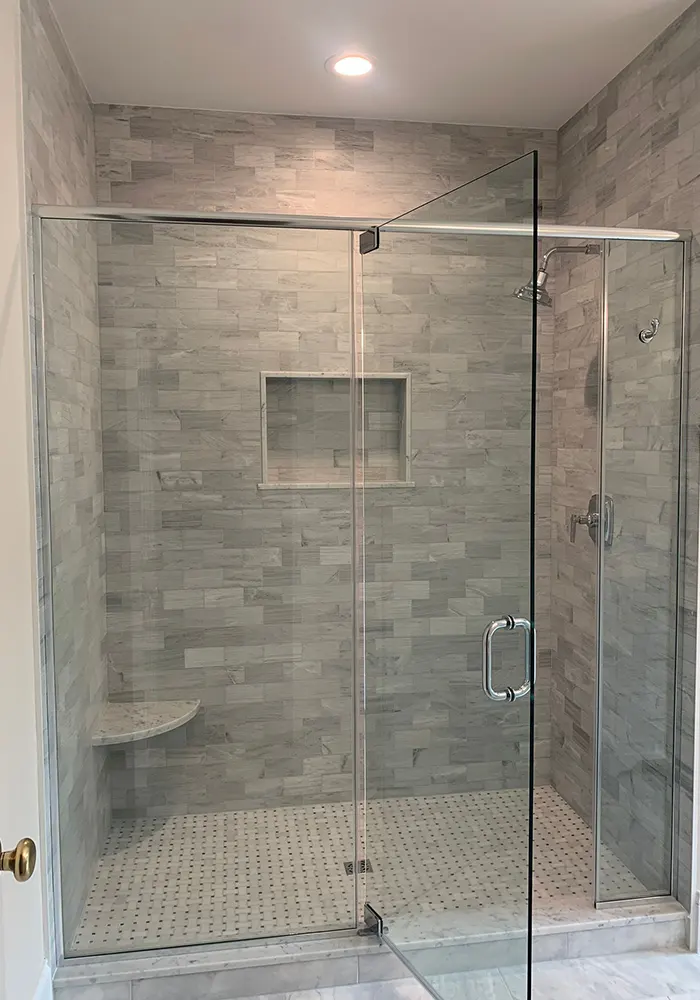 Glass-enclosed shower with stone-look tile